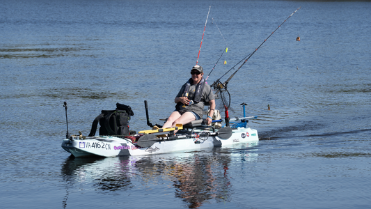 Angler using a Bixpy-powered fishing kayak on calm water
