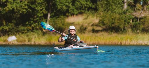 Kayaker using an Aqua Bound paddle on the water