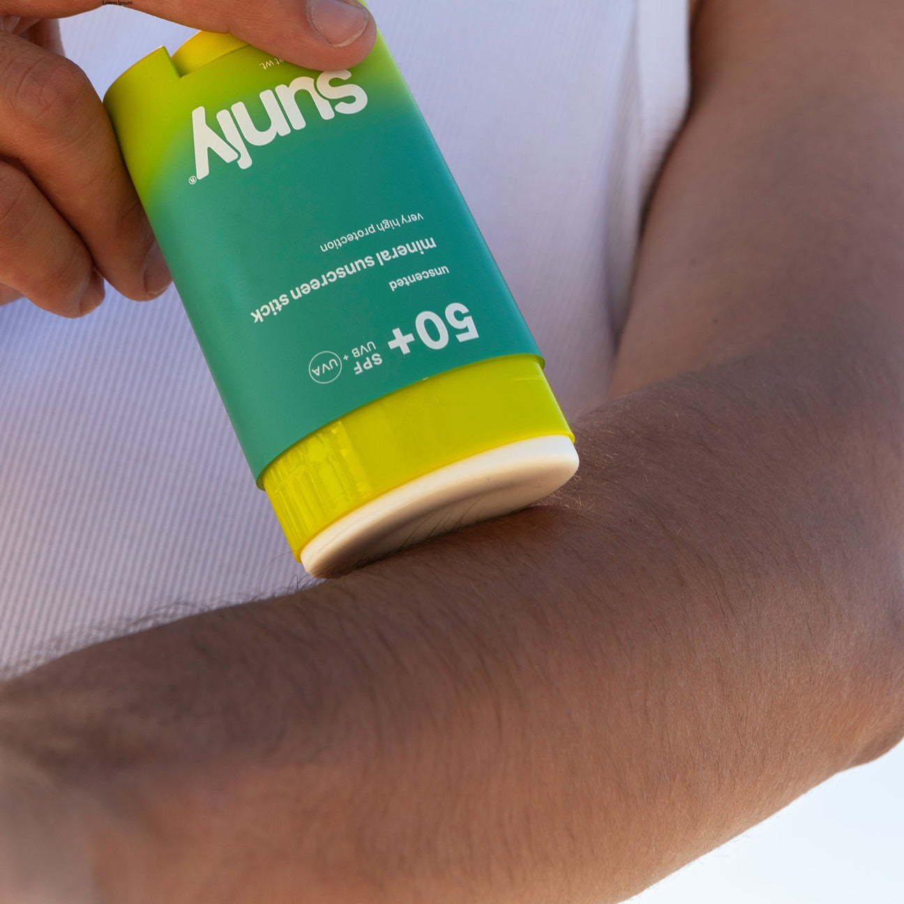 Sunly mineral sunscreen stick being applied outdoors