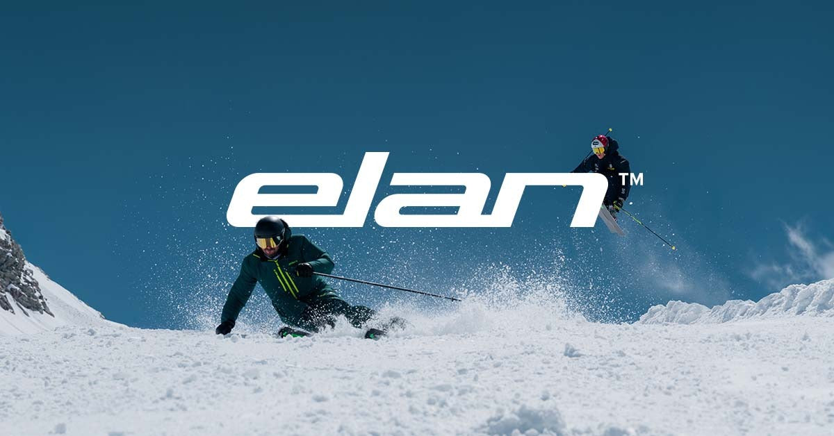Skiers crossing snowy backcountry terrain with Elan skis