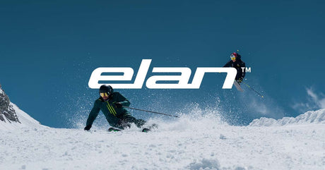 Skiers crossing snowy backcountry terrain with Elan skis