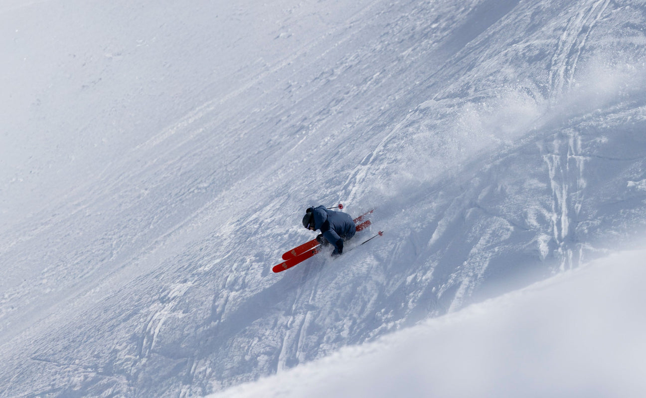Skier riding deep snow on DPS skis