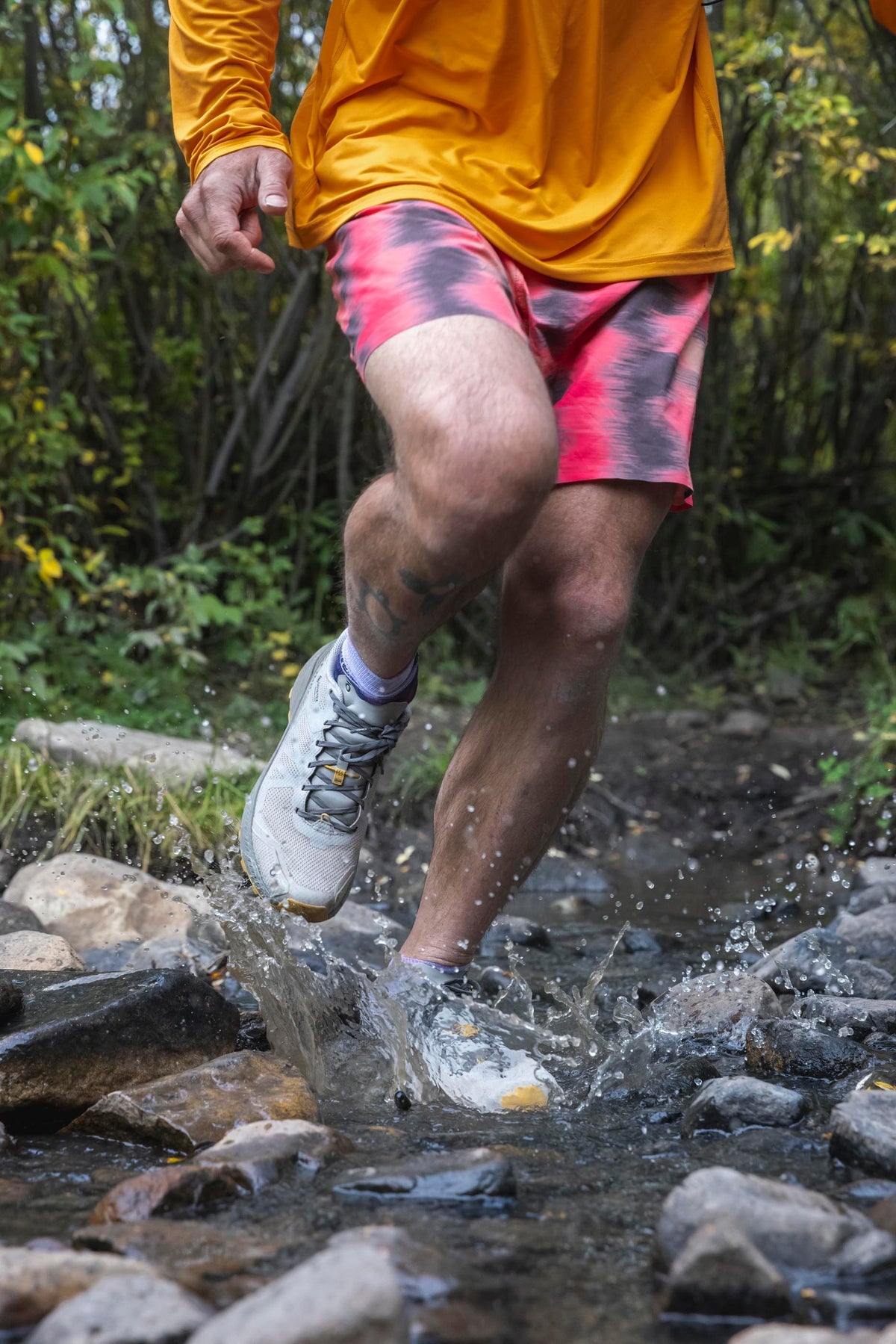 Hiker wearing Oboz footwear on rocky trail terrain