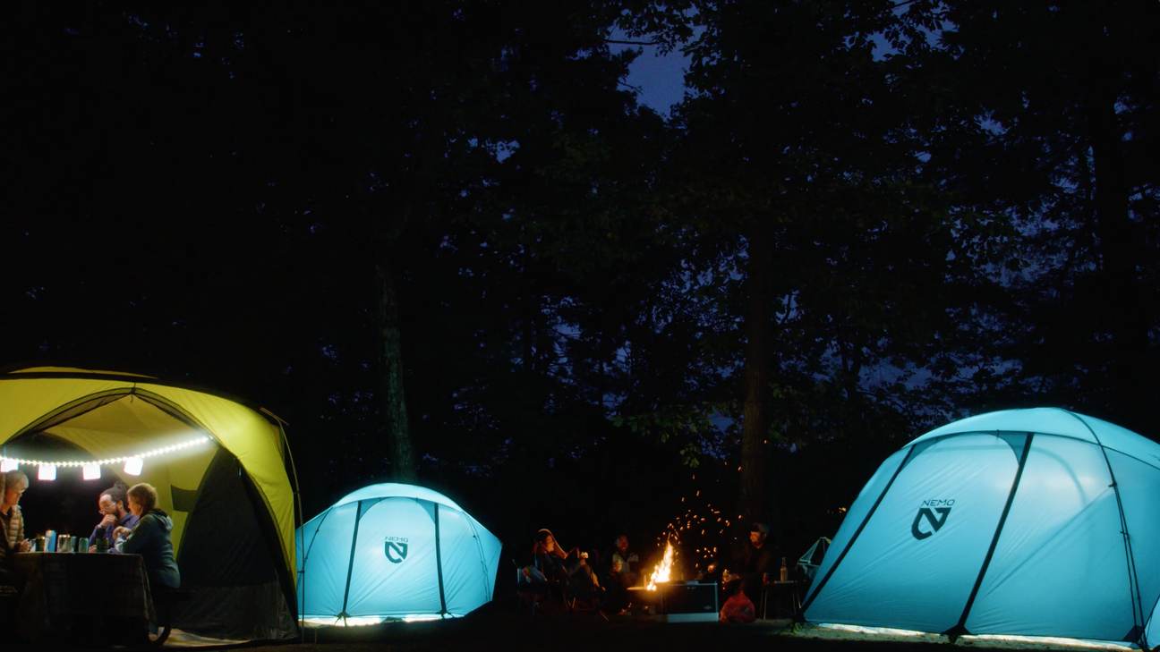 NEMO tents lit at night in camp