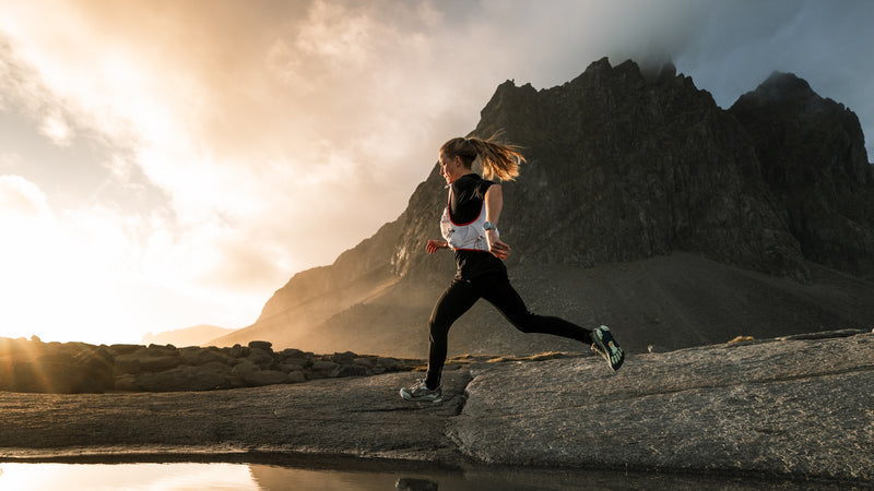 Trail runner wearing Altra shoes in mountain terrain
