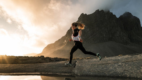 Trail runner wearing Altra shoes in mountain terrain