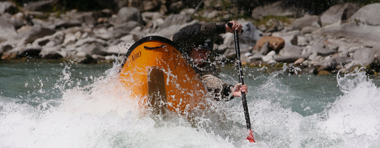 Esquif canoe paddling through whitewater