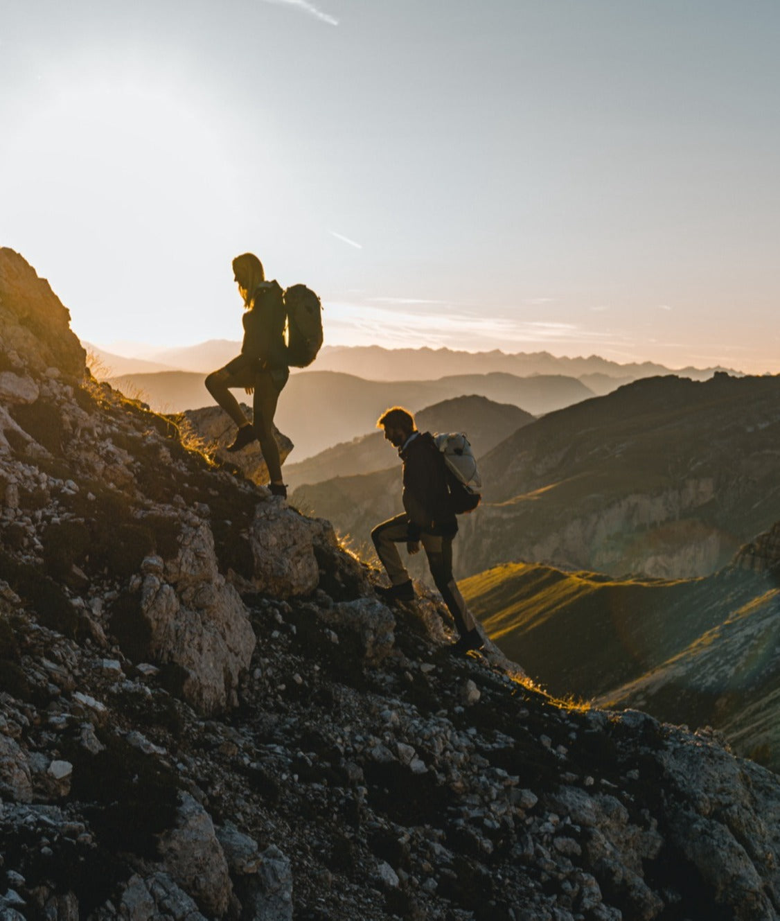 Hiker wearing a Mammut backpack on rocky terrain