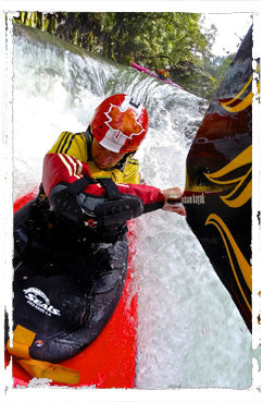 Paddler using a Seals neoprene spray skirt in whitewater