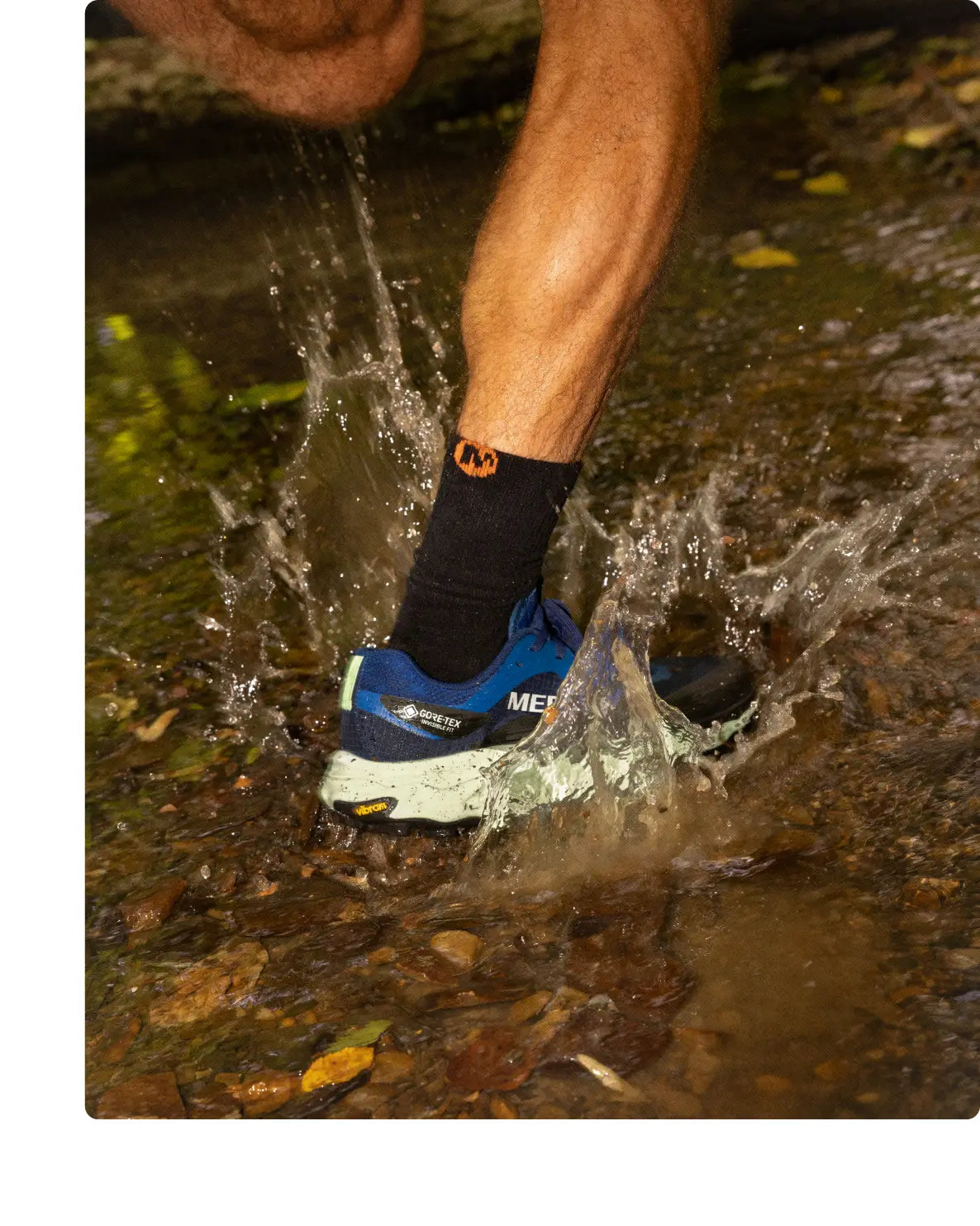 Runner on a trail wearing Merrell trail running shoes