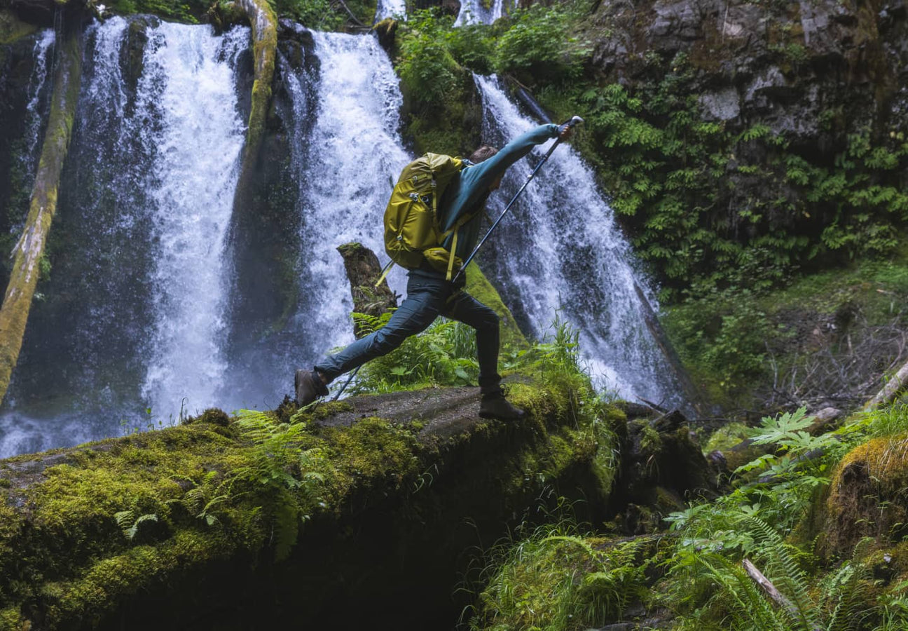 Osprey pack carried on a hiking trail near waterfalls