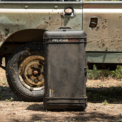 Pelican protective case beside an off-road vehicle