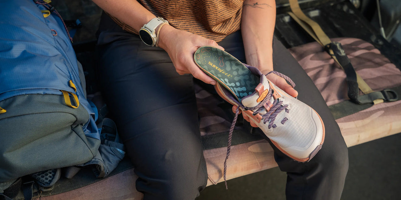 Superfeet insole being placed into a hiking shoe