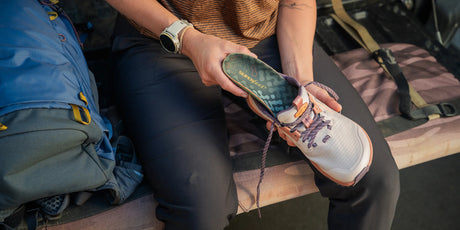 Superfeet insole being placed into a hiking shoe